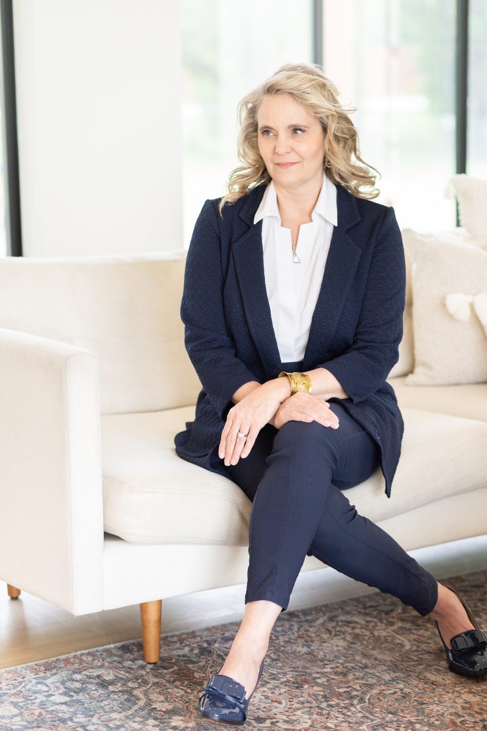 Dr. Amy seated on a white sofa