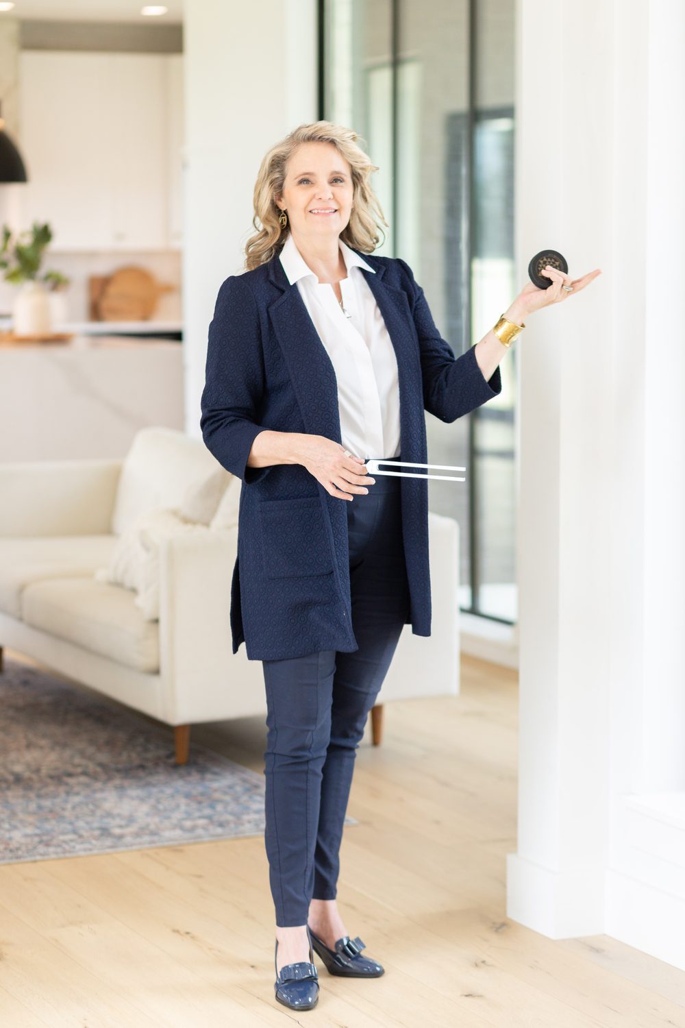 Dr. Amy standing with tuning forks